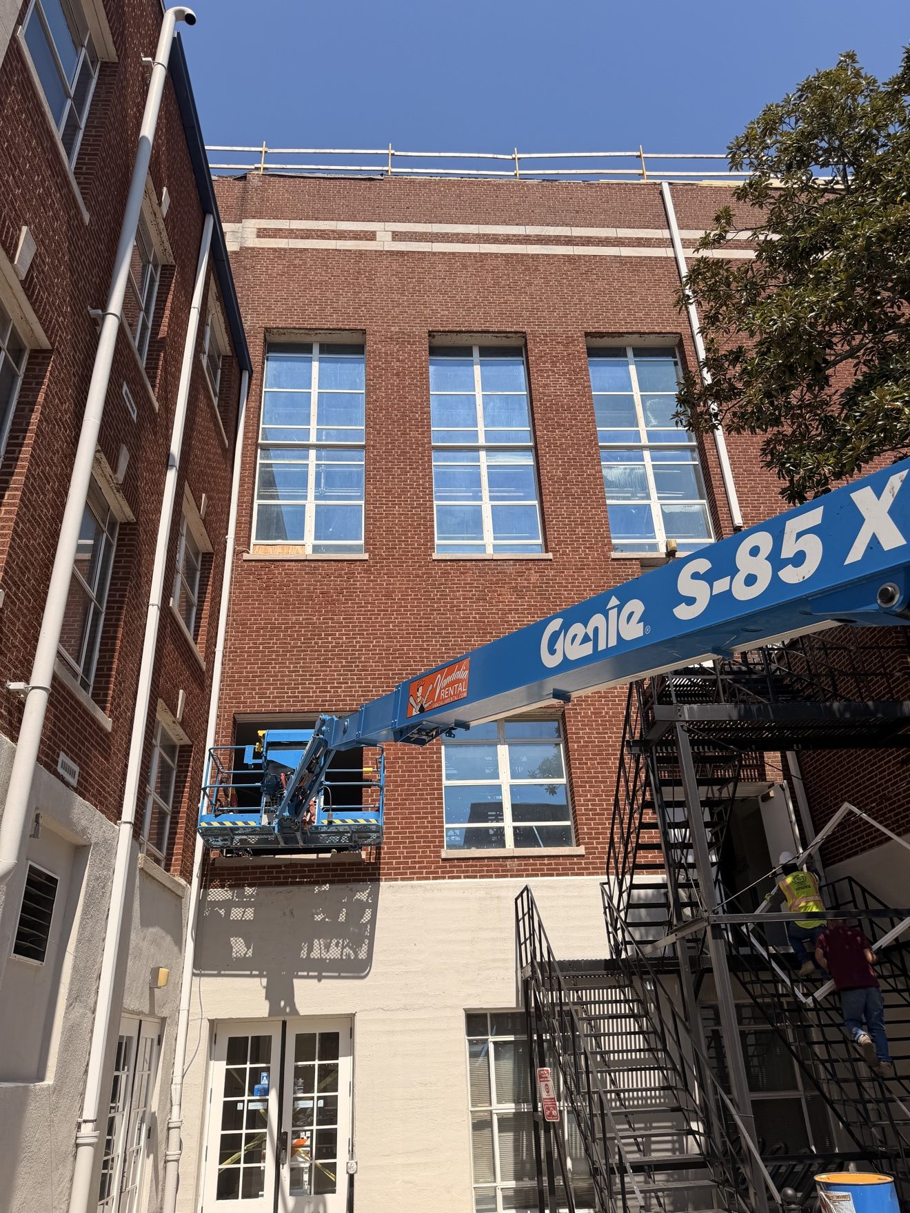 Window work from a Genie lift — brick building